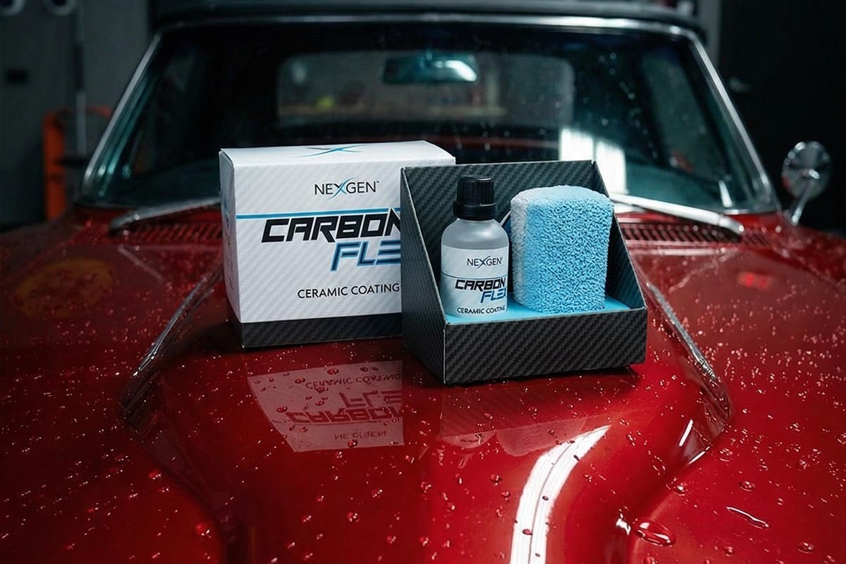 Carbon Flex bottle on glossy black hood with dramatic water beading
