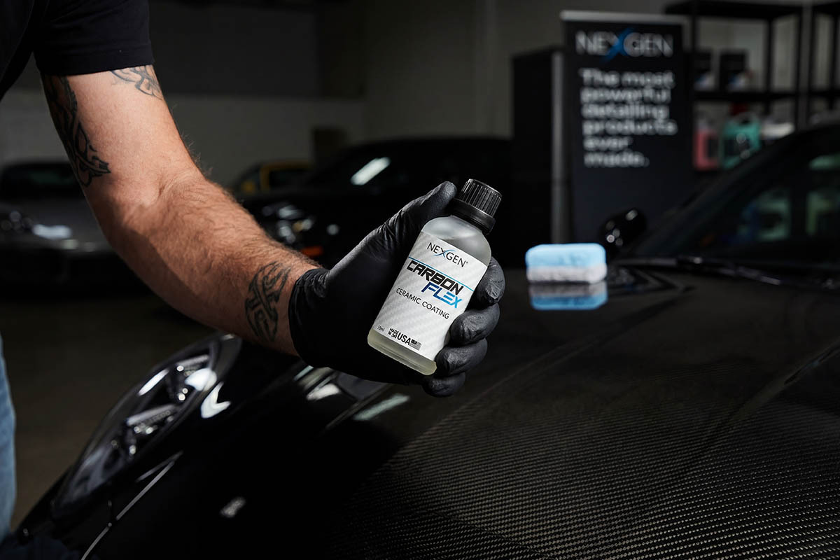 Carbon Flex bottle in a detailer's hand, garage setting